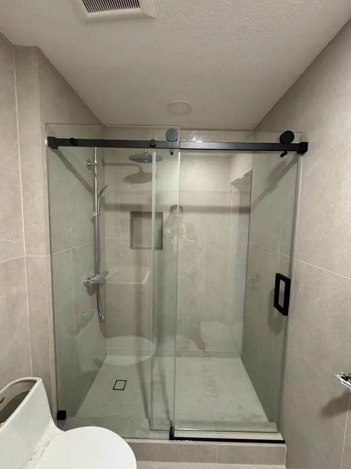 Matte black frameless single slider installed by Merlord