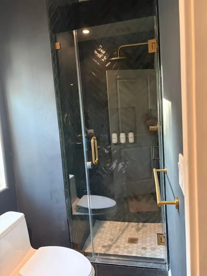 Hinged door with brushed gold handle installed by Merlord