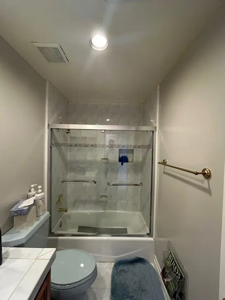 Framed sliding door over a bathtub installed by Merlord