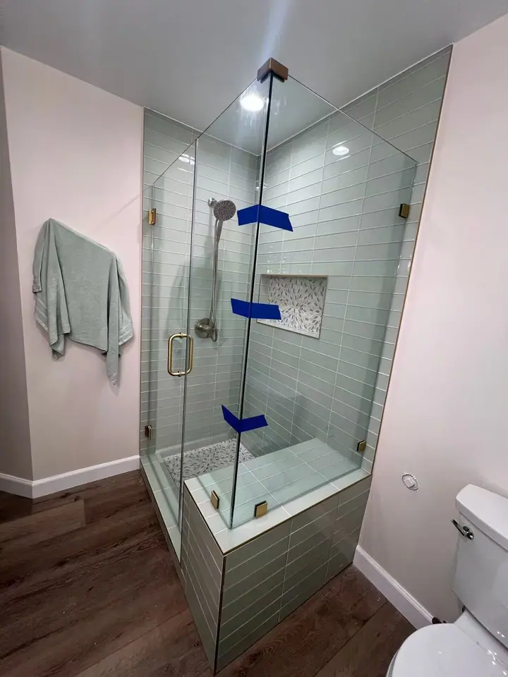 Corner enclosure on a tiled half wall installed by Merlord (photo 1 of 2)