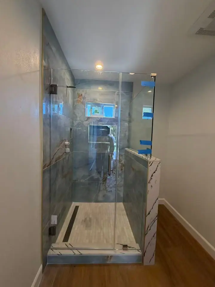 Half wall with glass-mounted door installed by Merlord