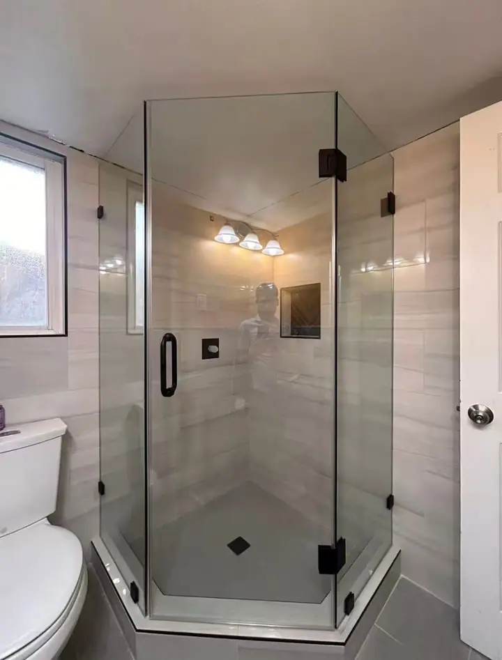 Neo-angle shower with black hardware installed by Merlord