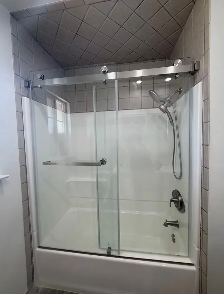 Bathtub sliding door in brushed nickel installed by Merlord