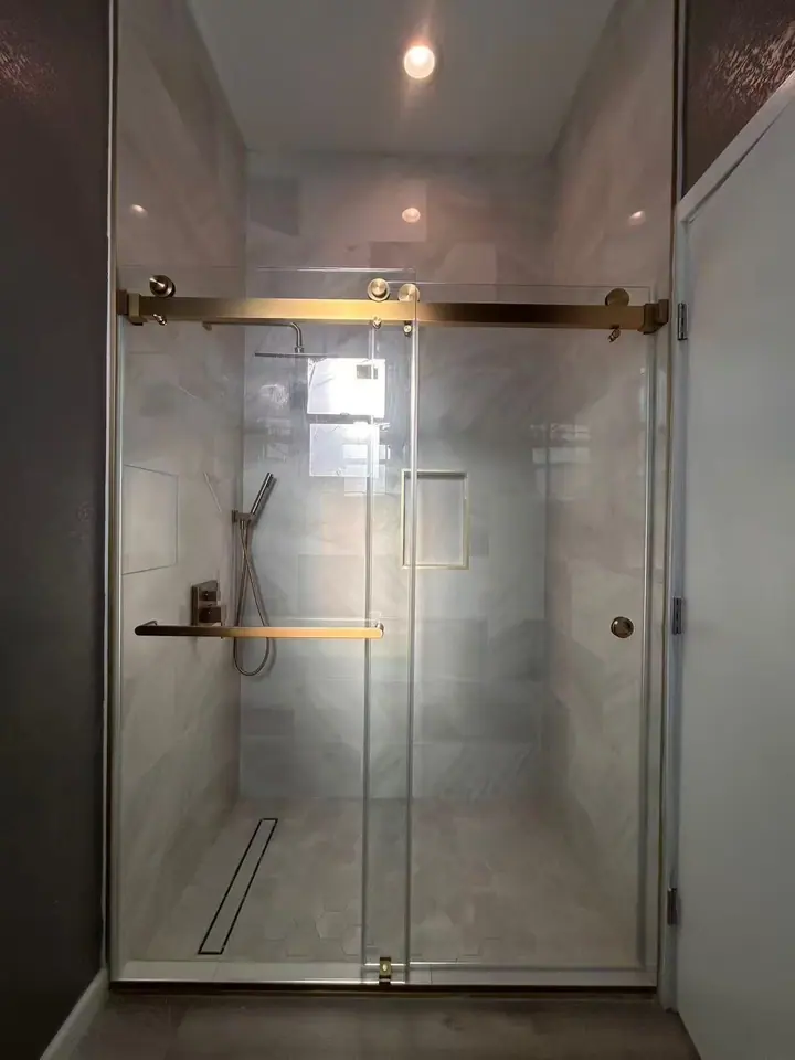 Sliding door with brushed gold rail installed by Merlord