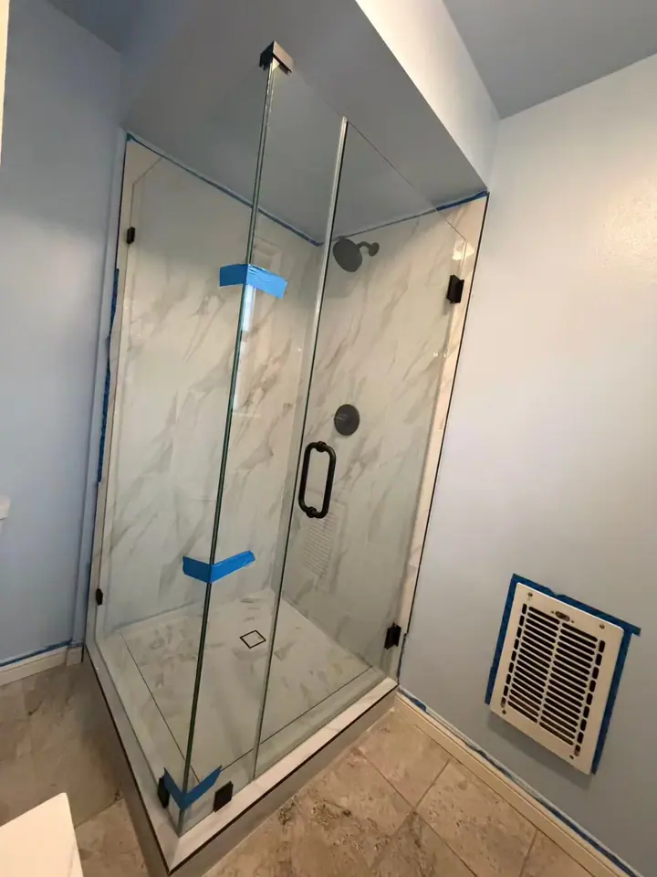 Corner enclosure with hinged door installed by Merlord